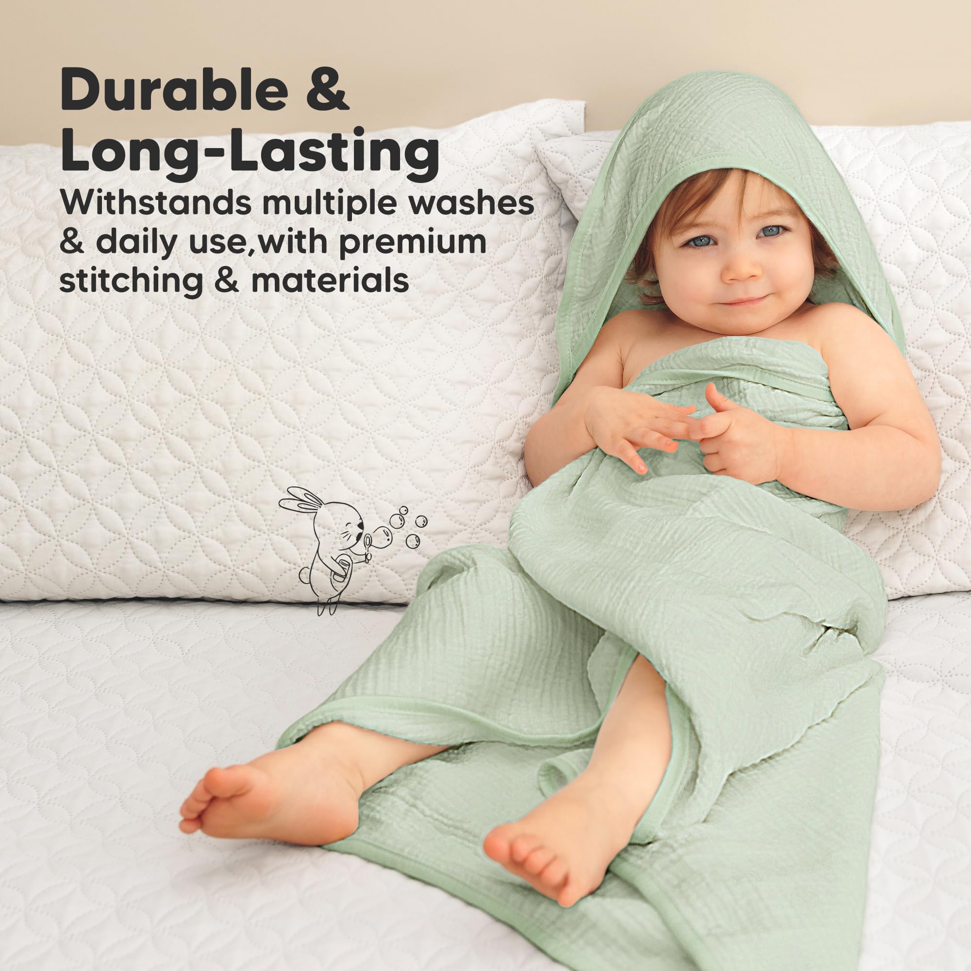 KeaBabies Lyra muslin hooded towel in bathroom with baby bath toys.
