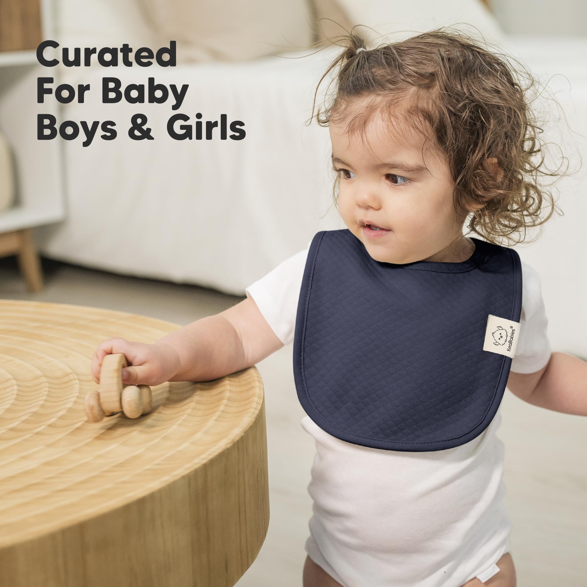 KeaBabies Urban Quin bib size coverage illustrated on a toddler torso.