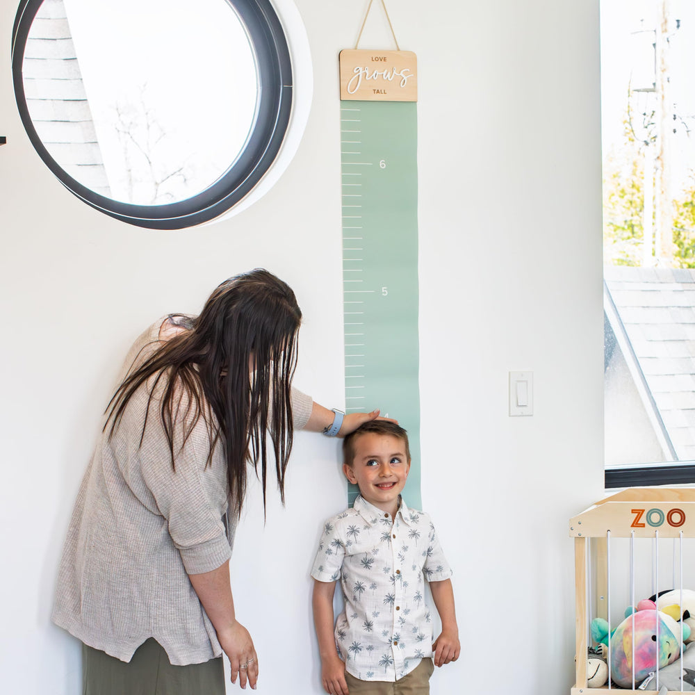 KIBAGA growth chart wall milestones close-up with milestone markers and easy writing area.