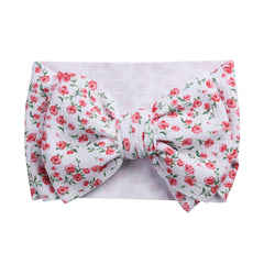 KIDOCHEESE big bows headband on a smiling baby showing comfortable elastic fit.