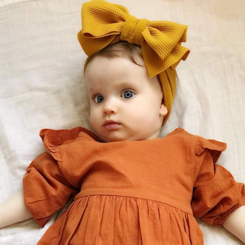KIDOCHEESE big bows headband soft-material close-up demonstrates non-slip, comfy wear.