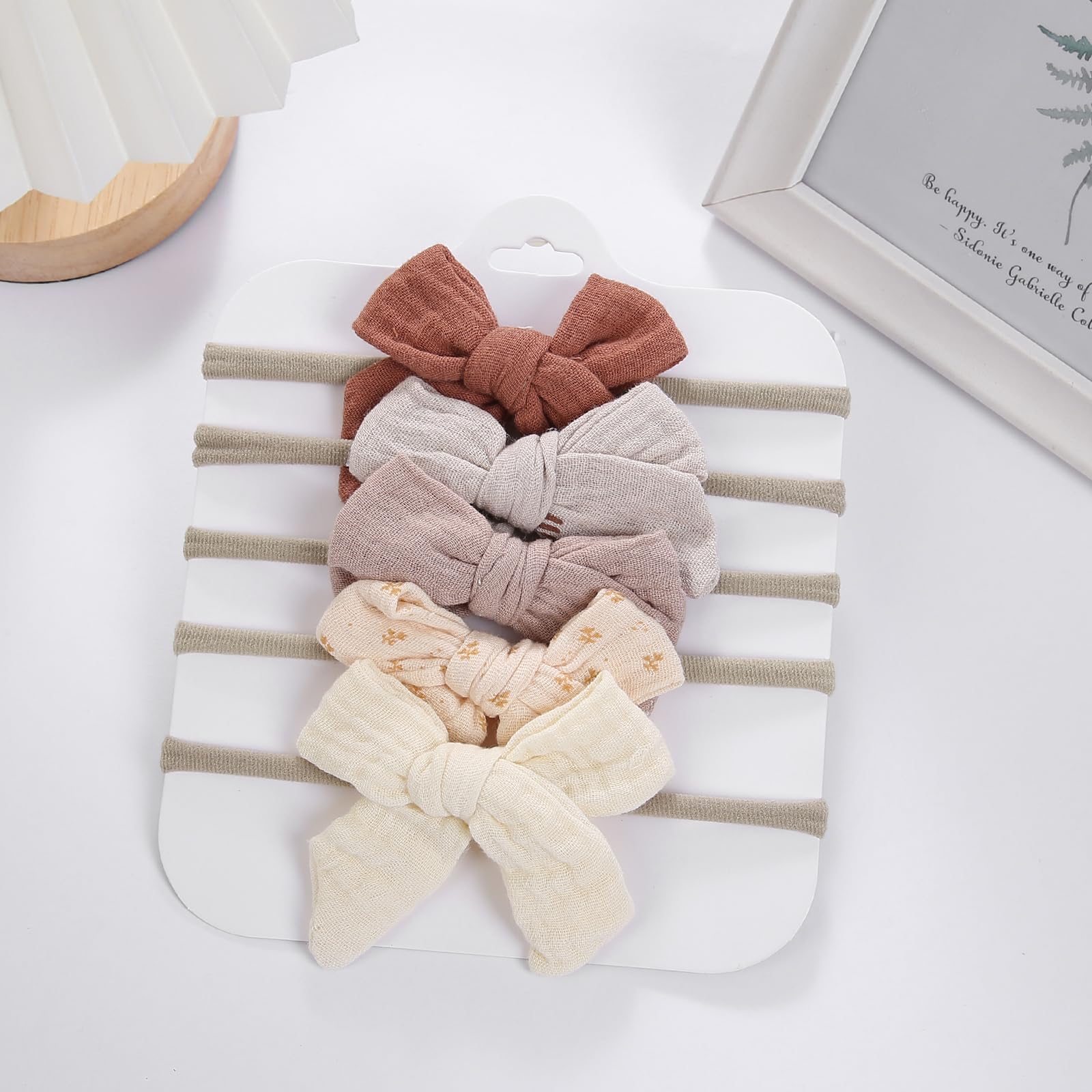 KIDOCHEESE newborn photoshoot bow enhances outfits for keepsake photos.
