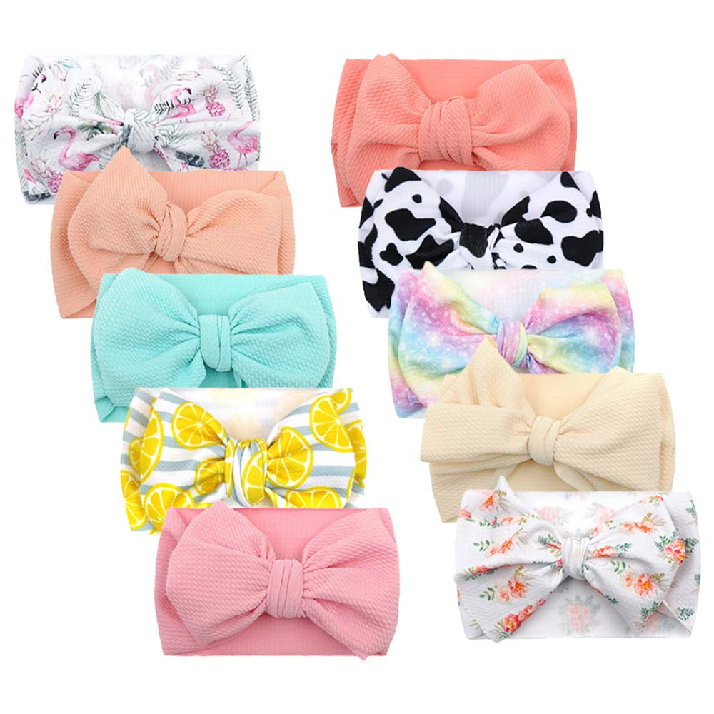 KIDOCHEESE oversized bow headband fits newborns for comfortable all-day wear.