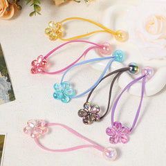 Kifmurase yellow camellia ball hair tie provides bright accent with secure, comfortable hold.