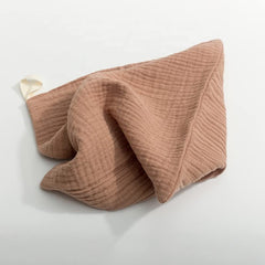 Kjuti muslin burp cloths in pastel stack, breathable and gentle on skin.