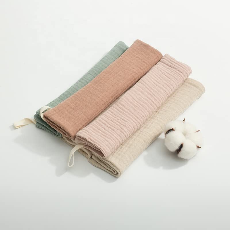 Kjuti organic muslin burp cloths spread for gentle face-wipe use.