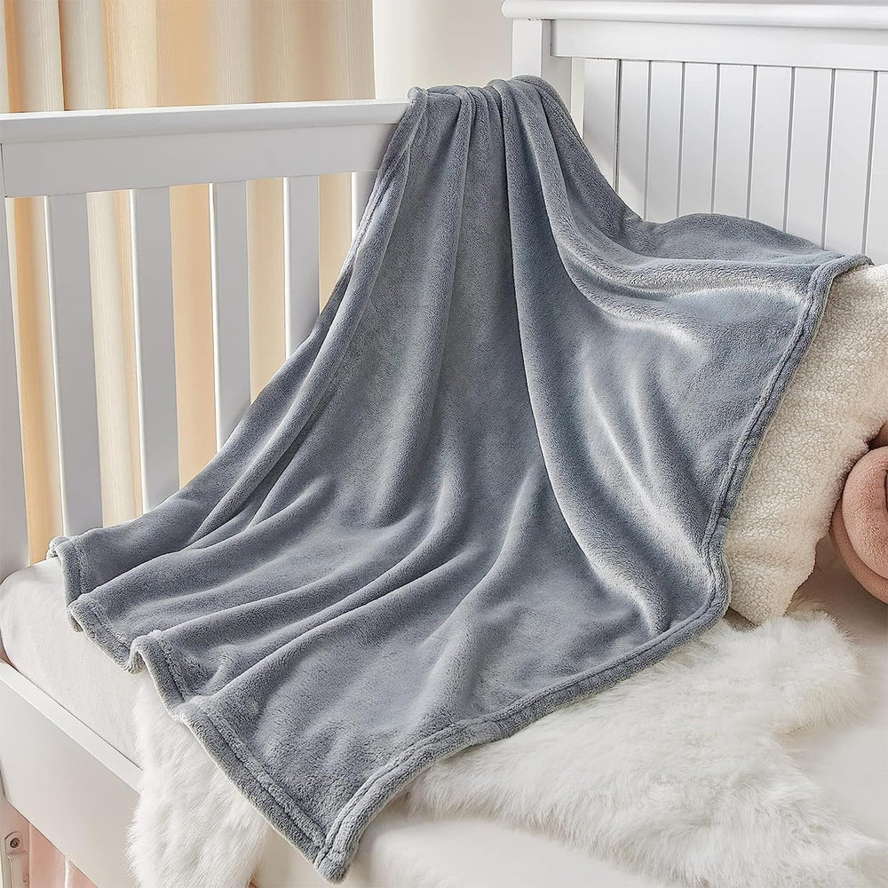 KMUSET blanket grey fabric closeup shows soft microfiber texture and gentle touch.