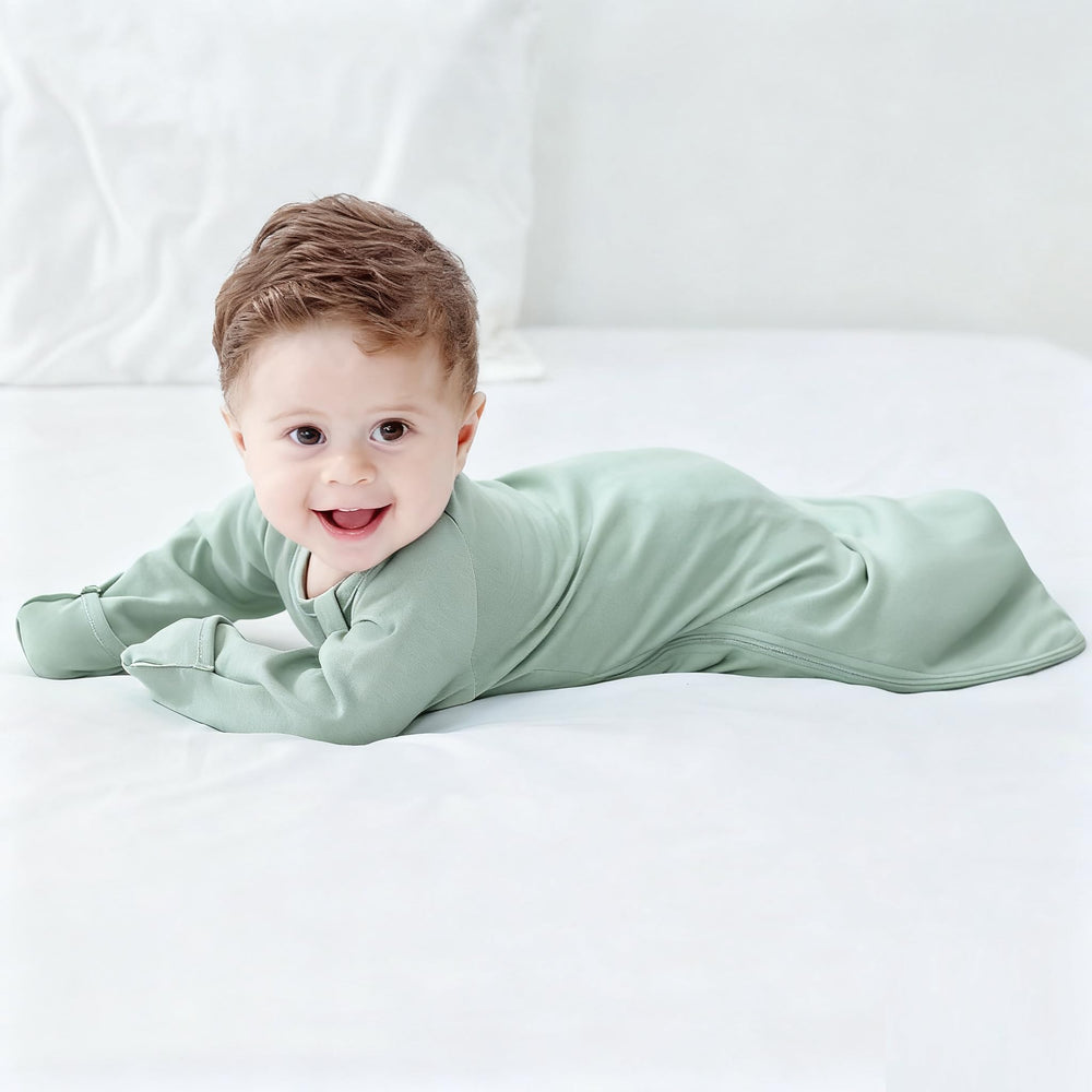 Knirose Swaddle Sack showing air-access as baby shifts onto tummy.
