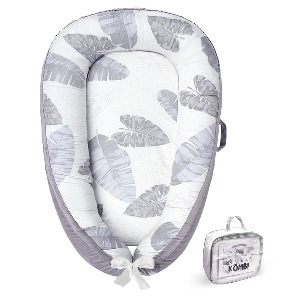 Kombi Baby Lounger nest gray front view highlights organic cotton and 360° bumpers for newborn comfort.