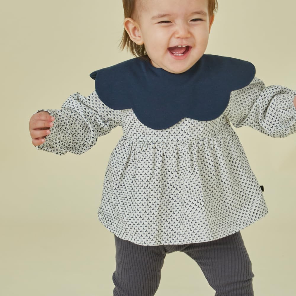 Konny Baby Bibs worn by baby during meals and play for on-the-go practicality.