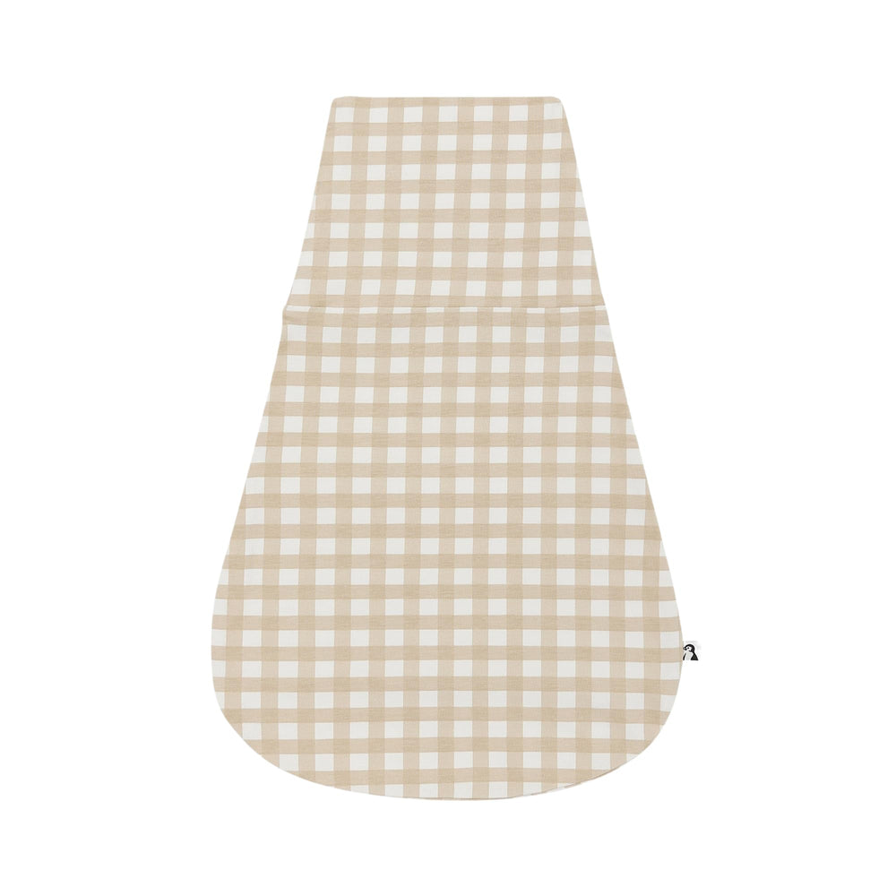 Konny Newborn Swaddle Pouch in creamy gingham on baby promotes snug comfort.