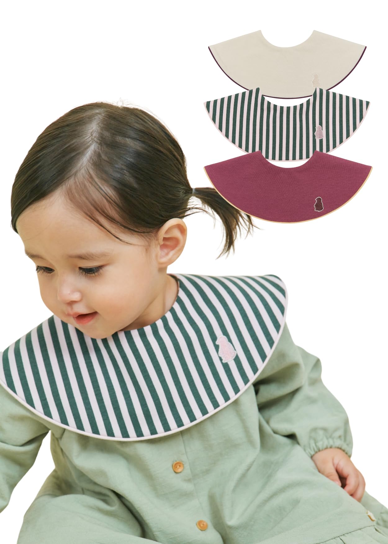 Konny Piped Edge Bib Neutral Beige demonstrates soft fabric for gentle feeding protection.