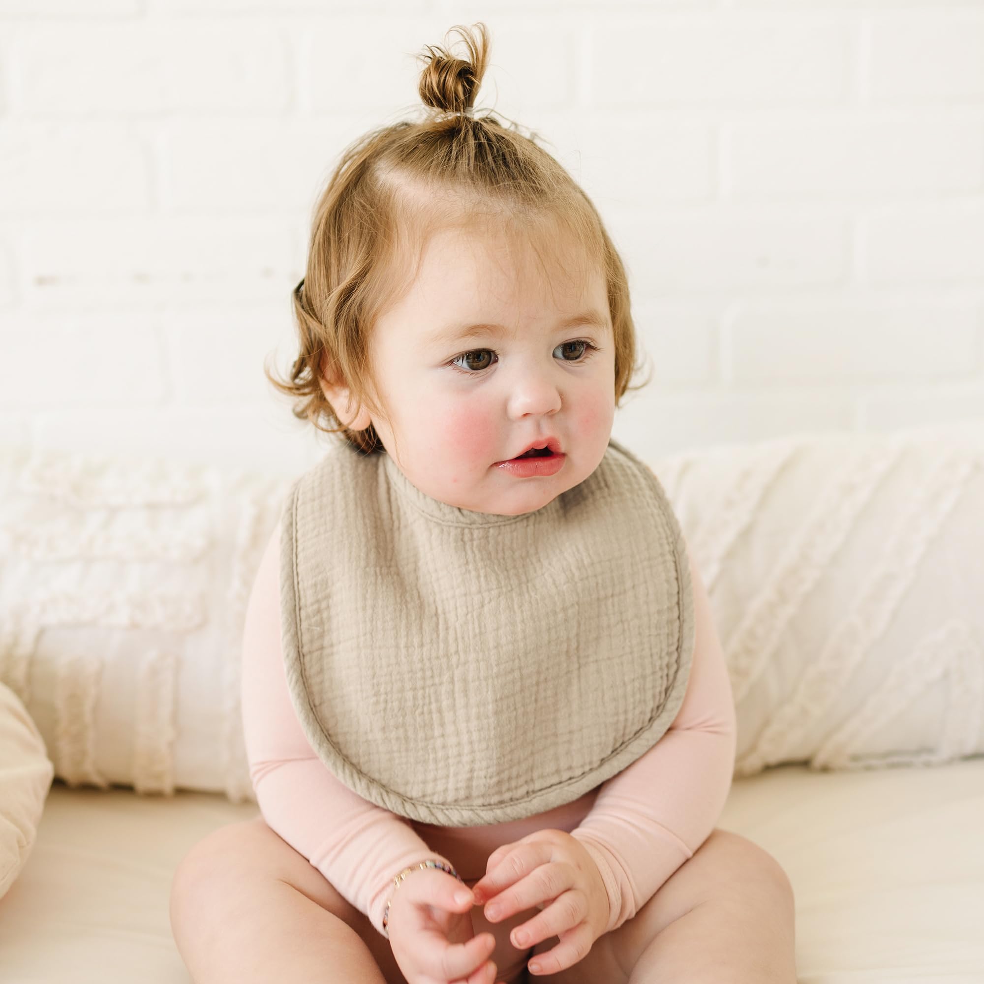 Konssy bibs worn on baby during feeding or drool moments.