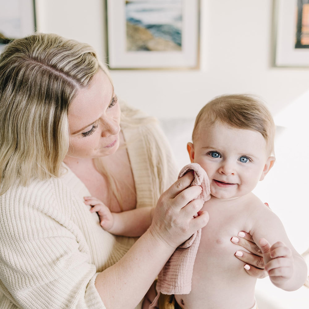 Konssy washcloths shown as burp cloths demonstrate multi-use practicality.