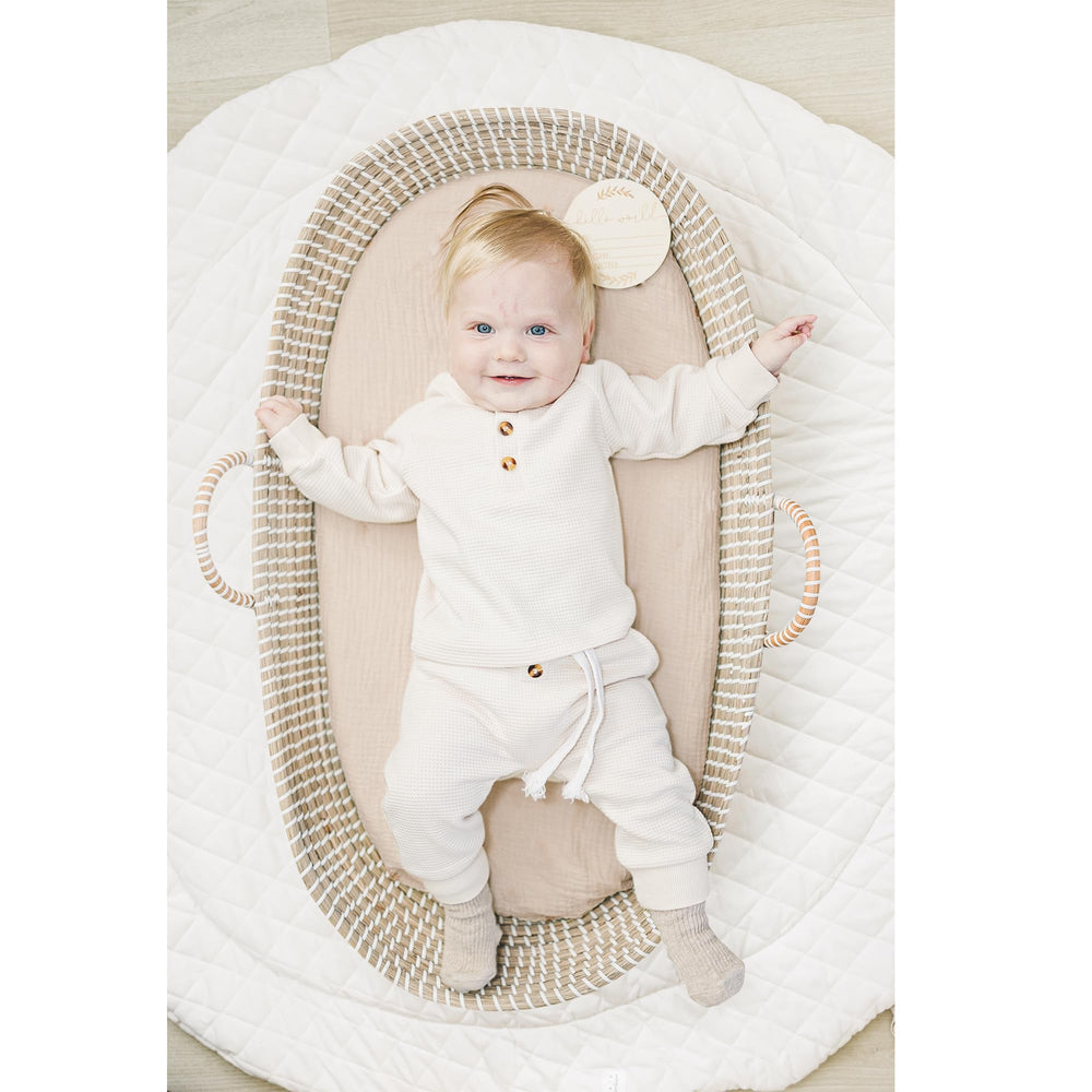 Konssy navy and cream style sheets match most nurseries with neutral tones.