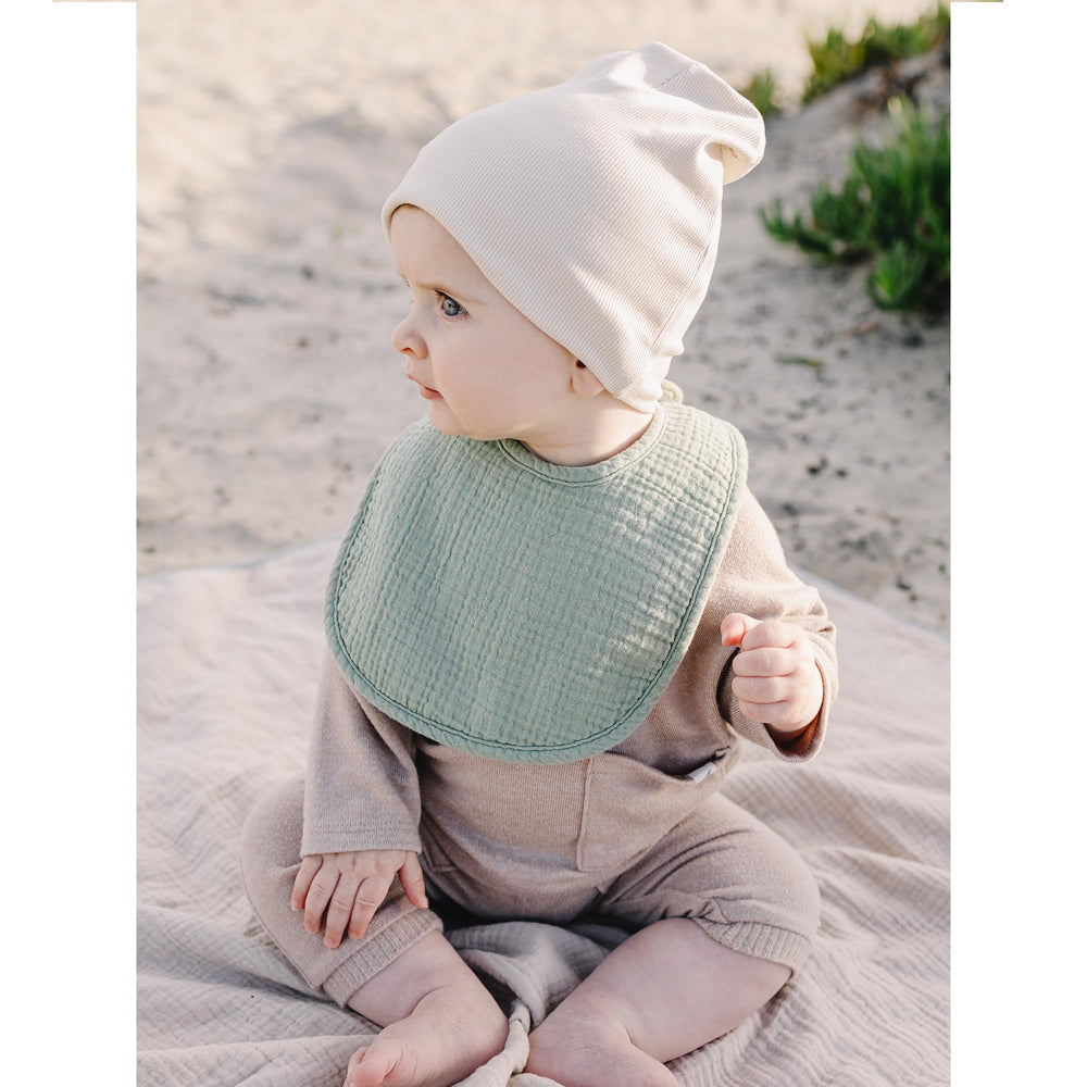 Konssy Muslin Baby Bibs laid flat demonstrating multi-use as bib, burp cloth, wipe.