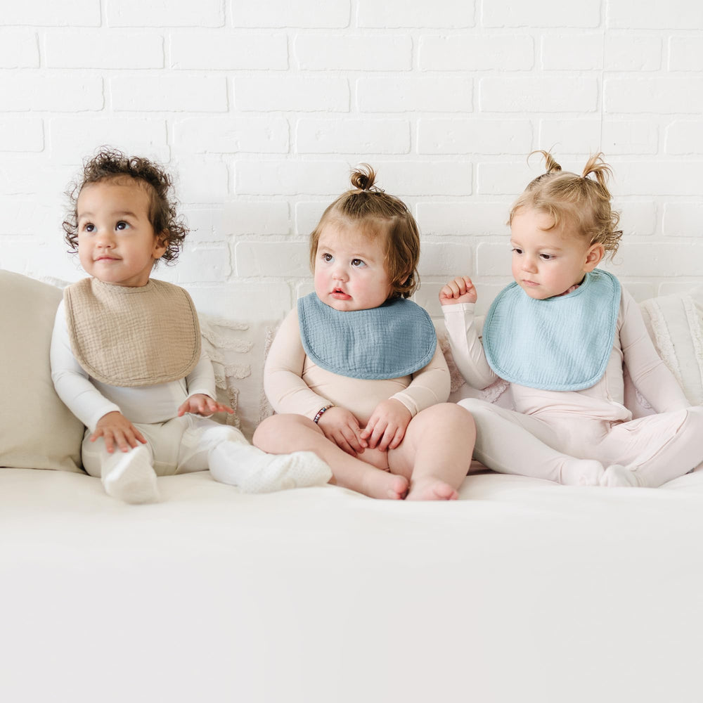 Konssy muslin baby bibs back view showing absorbent polyester backing for moisture control.