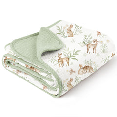 Konssy muslin blanket woodland pattern on crib for cozy nursery decor.