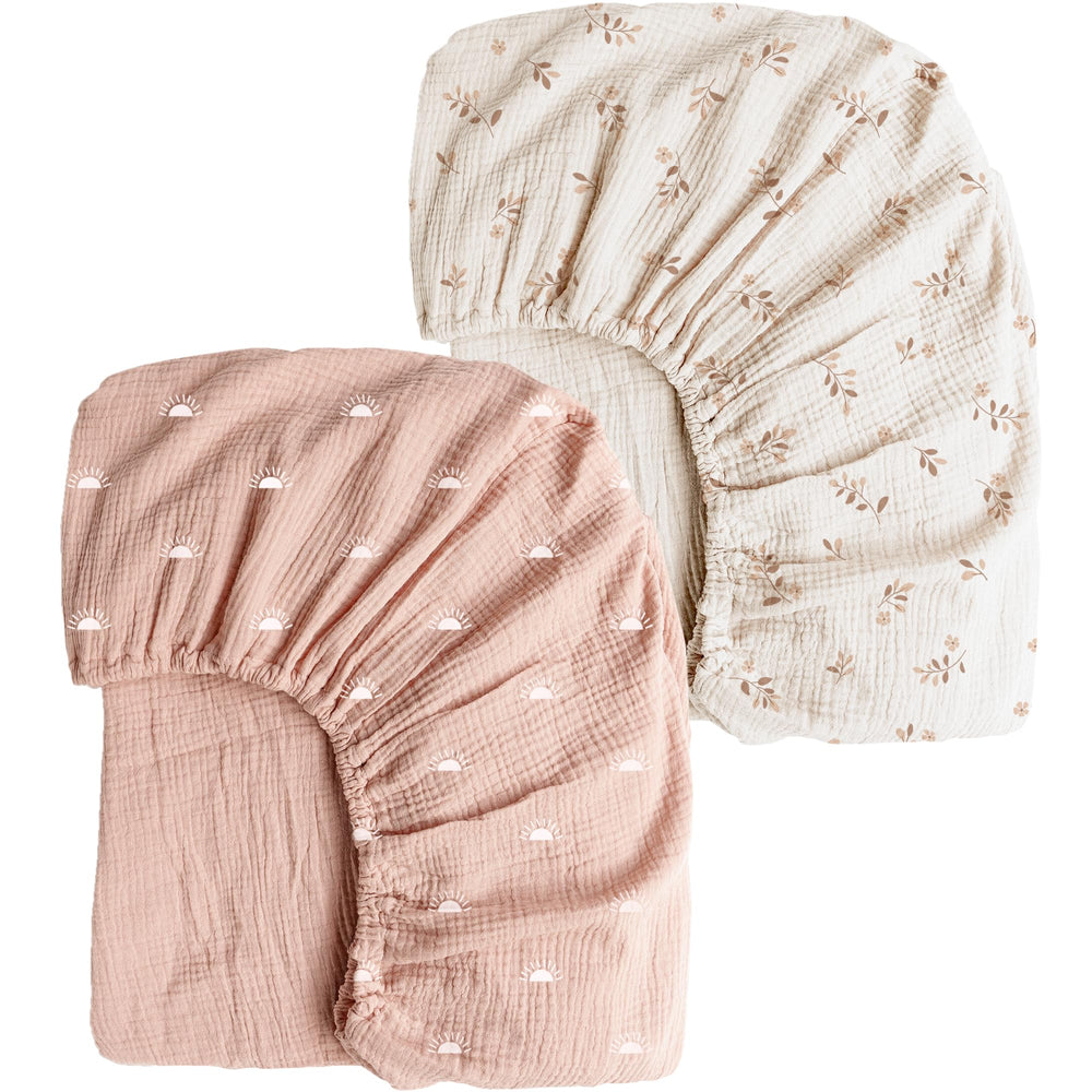 Konssy muslin crib sheet in pink sun offers breathable comfort for baby naps.
