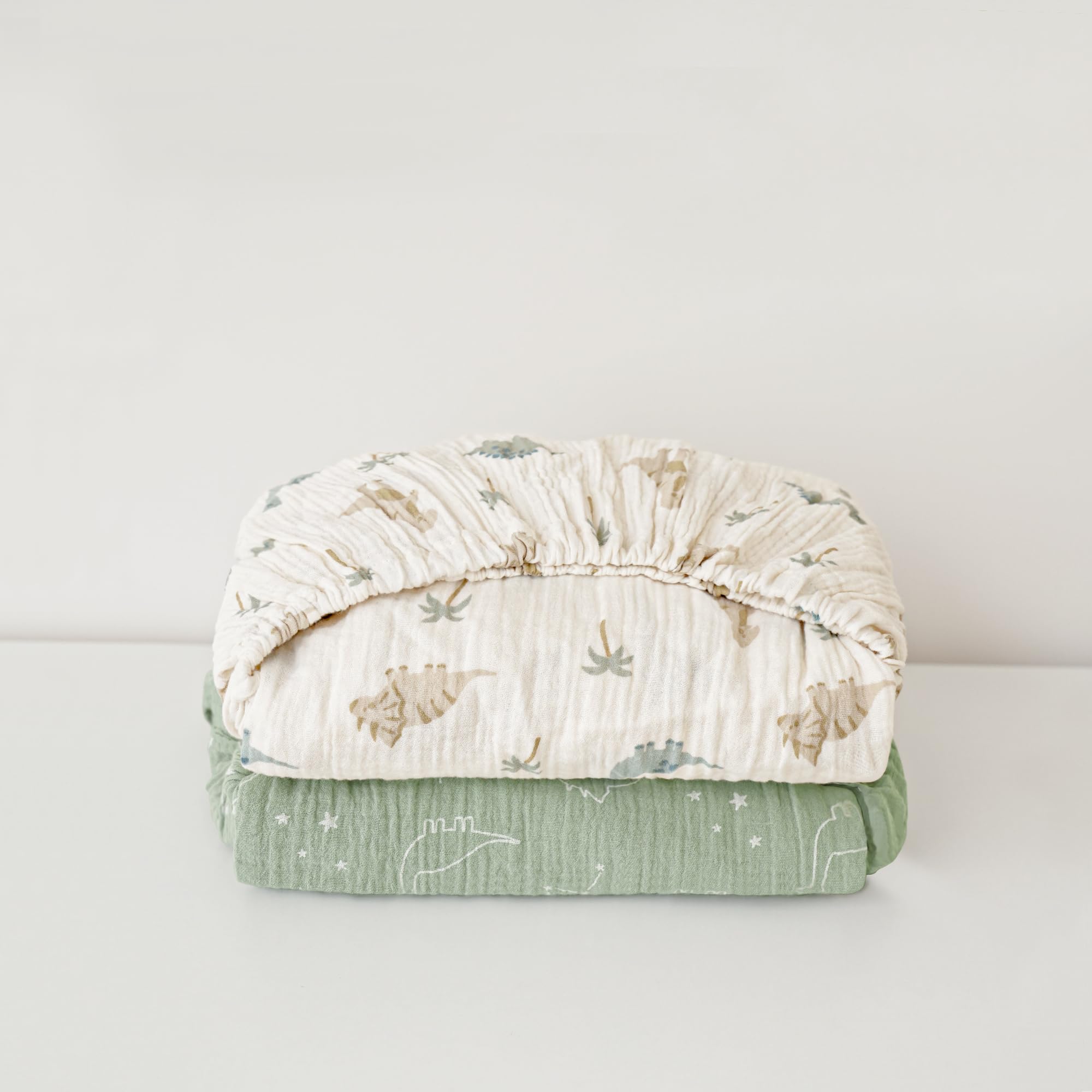 Konssy muslin crib sheets Sage Dino provide plush comfort for cozy nights
