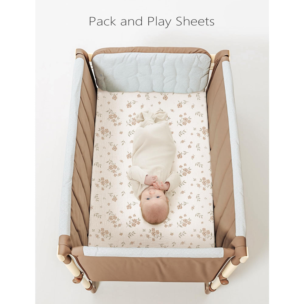 Konssy muslin mini crib sheets feature baby-girl blossom pattern adding nursery charm.