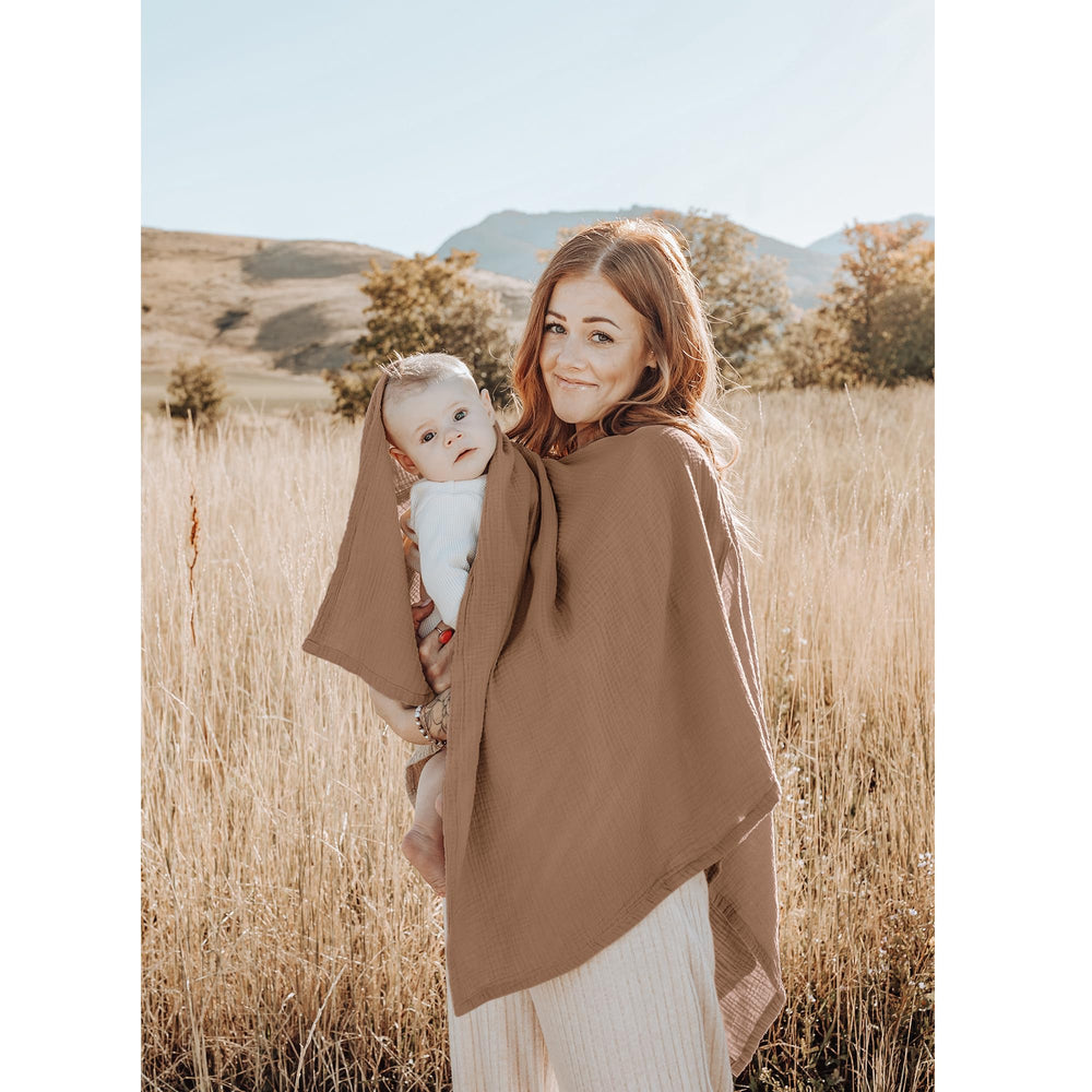 Konssy muslin nursing cover used as car-seat canopy for sun and dust protection.