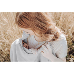 Konssy Muslin nursing cover used as car seat canopy for privacy and shade on the go.