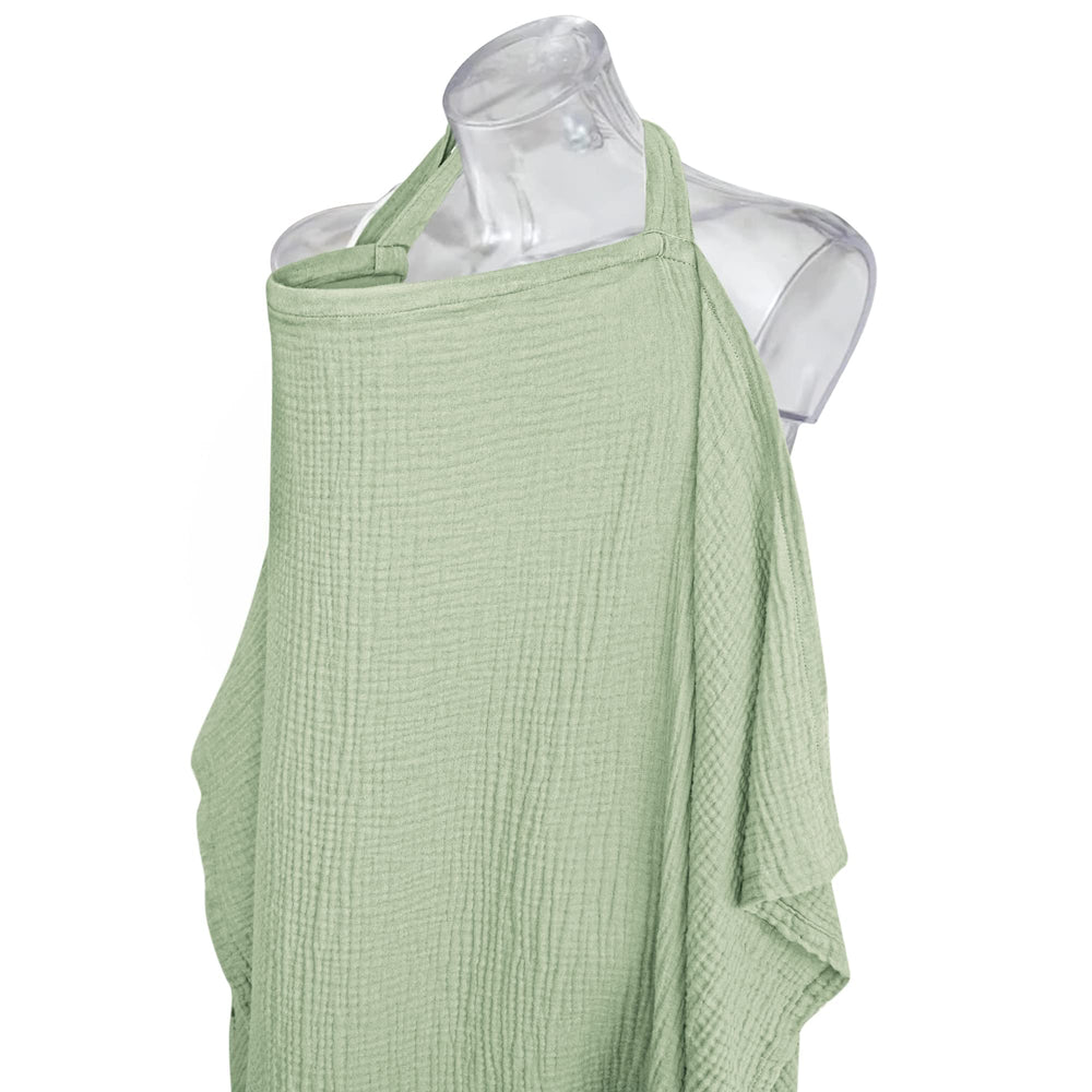 Konssy sage nursing cover used as car seat canopy for privacy.