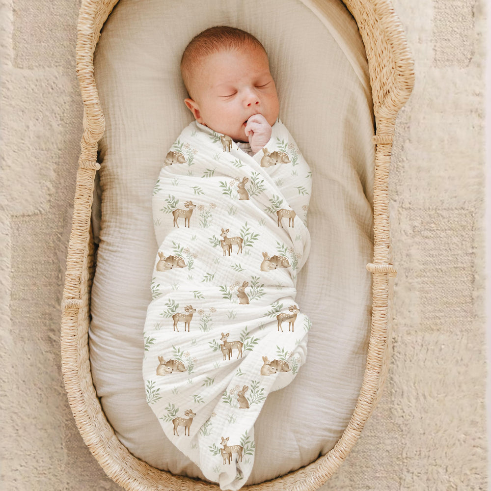 Konssy muslin swaddle blanket wrapping baby, showcasing large 47x47 inch swaddle surface.