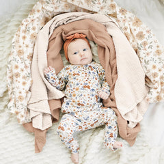 Konssy muslin swaddle fabric close-up reveals breathable cotton weave and gentle touch.