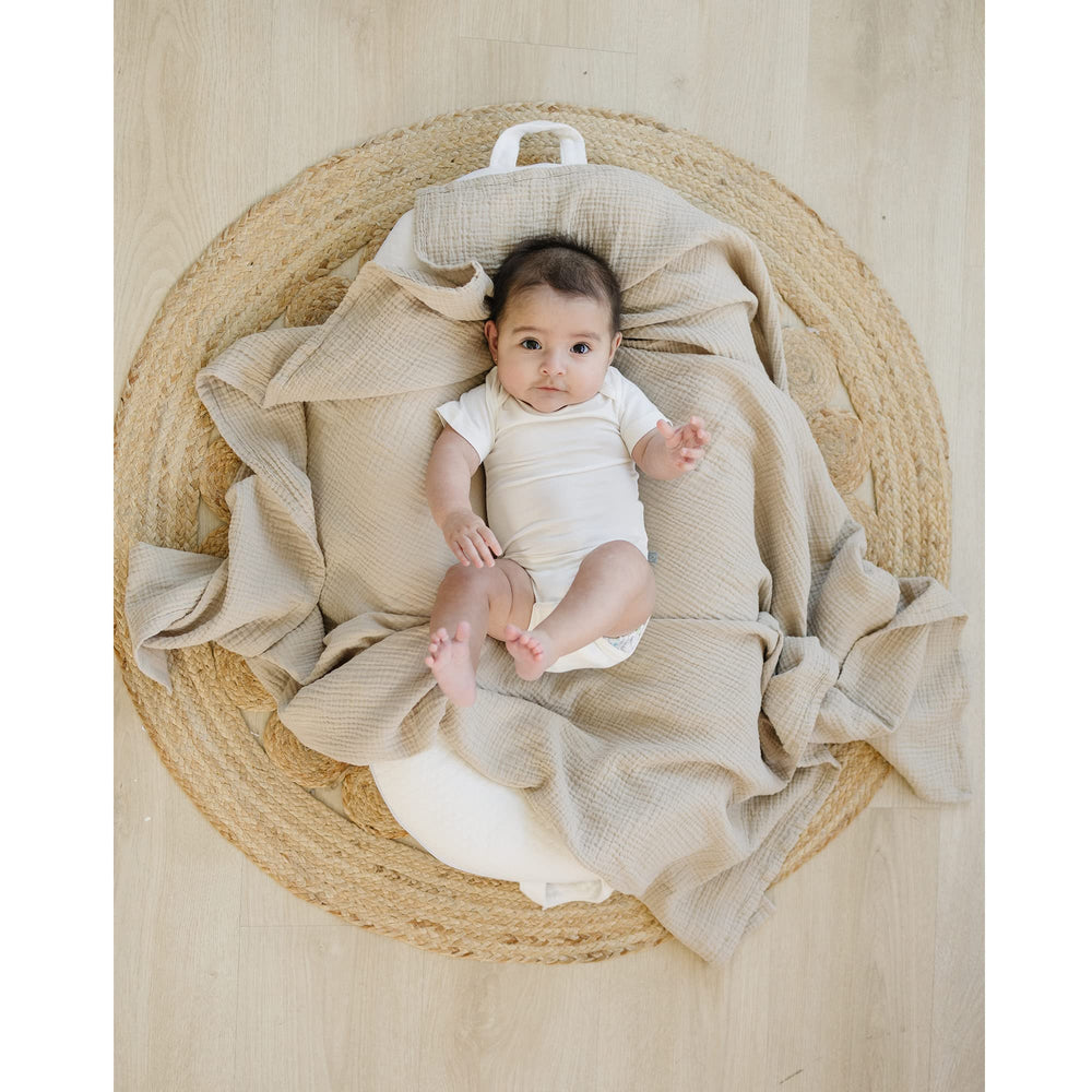 Konssy swaddle blanket used as photography prop highlights soft textures in baby portraits