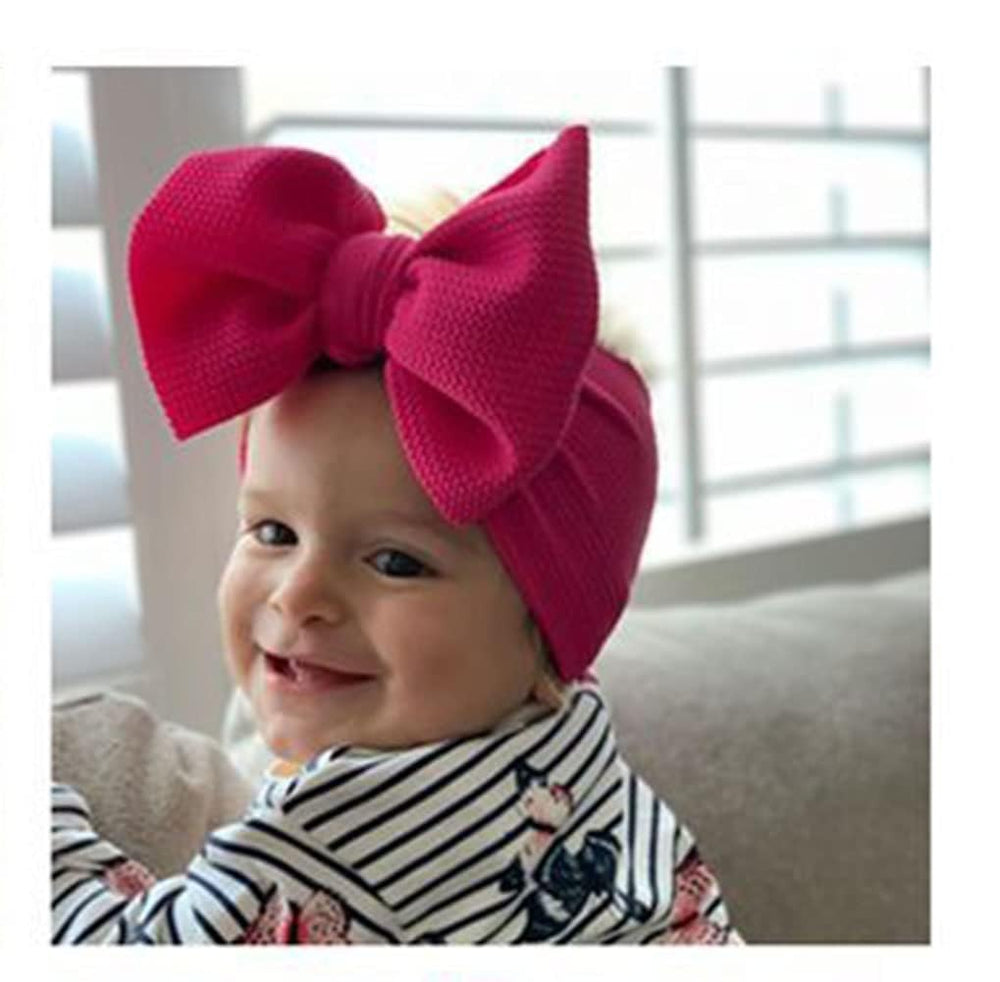 Koolgil baby bow headband fuchsia flat lay showing elastic fit for all-day use.