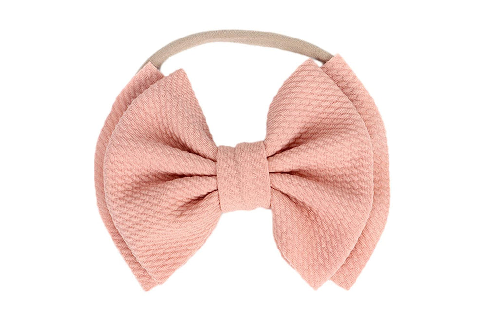 Koolgil bow-knot headband in blush pink—soft nylon for comfortable photography sessions.