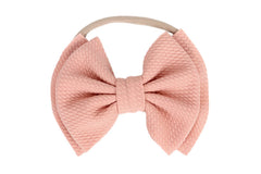 Koolgil bow-knot headband in blush pink—soft nylon for comfortable photography sessions.