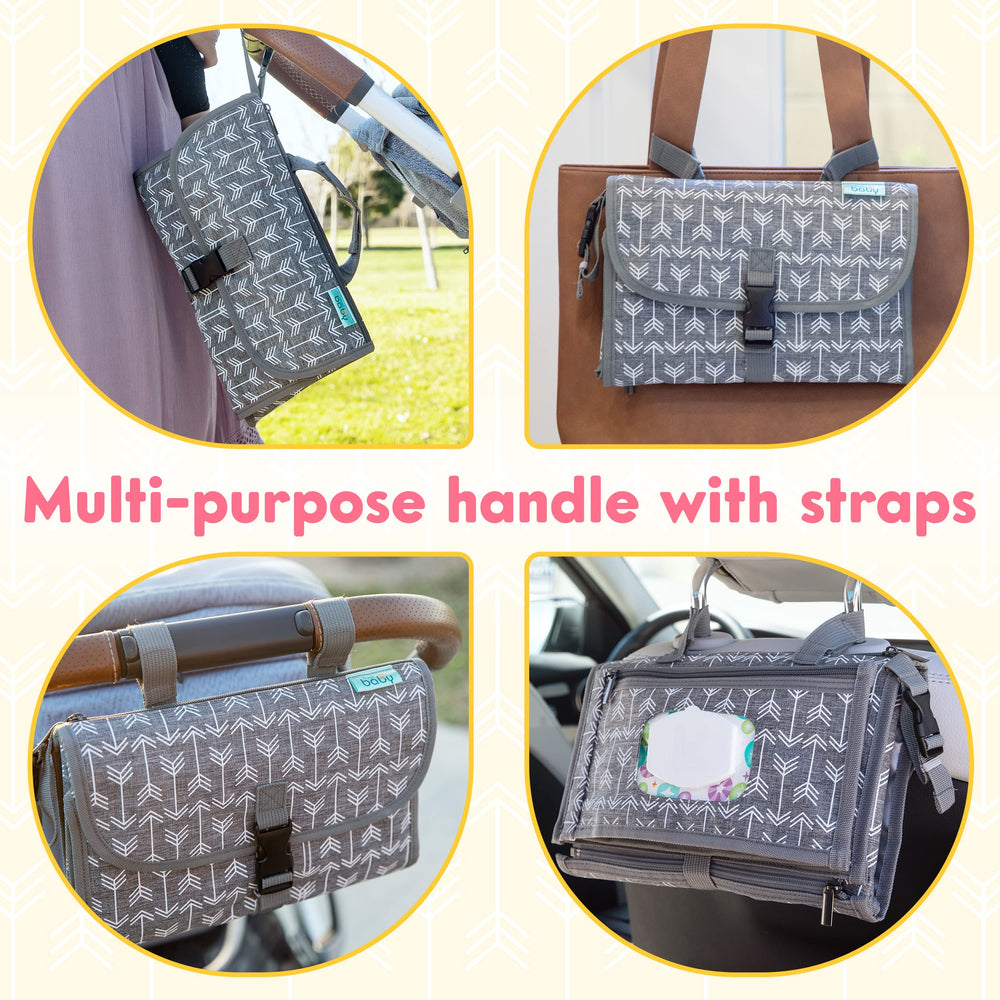 Kopi Baby changing pad attached to stroller with straps for easy on-the-go changes.