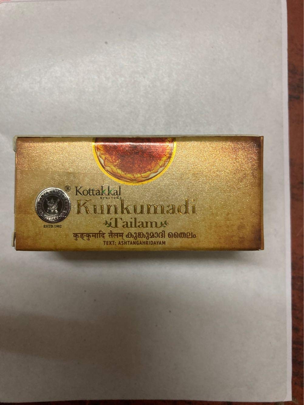 Kottakkal Arya Vaidya Sala Kunkumadi Tailam oil drops on skin for soothing routine