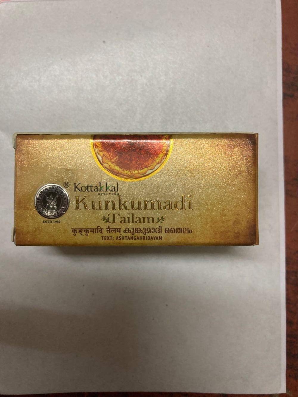 Kottakkal Arya Vaidya Sala Kunkumadi Tailam oil drops on skin for soothing routine