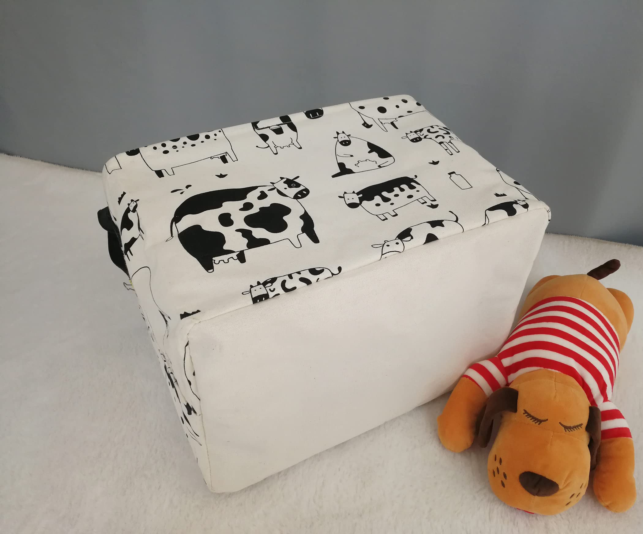KUNRO Rectang Cow Storage Basket filled with toys keeps the room tidy.