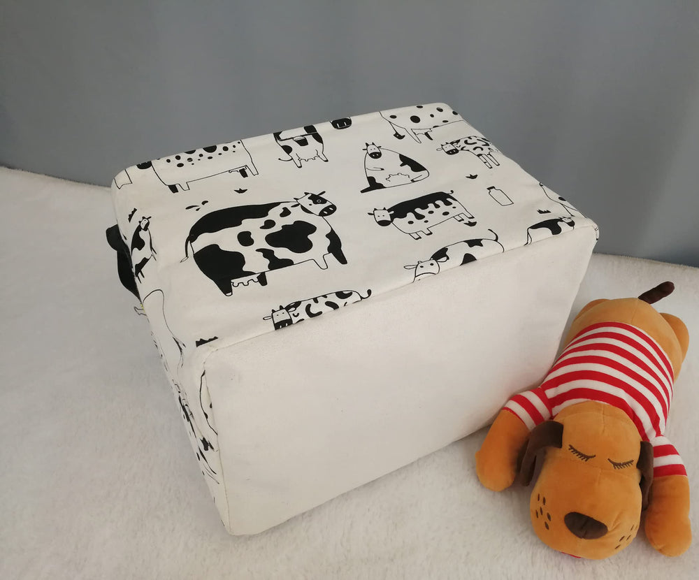 KUNRO Rectang Cow Storage Basket filled with toys keeps the room tidy.