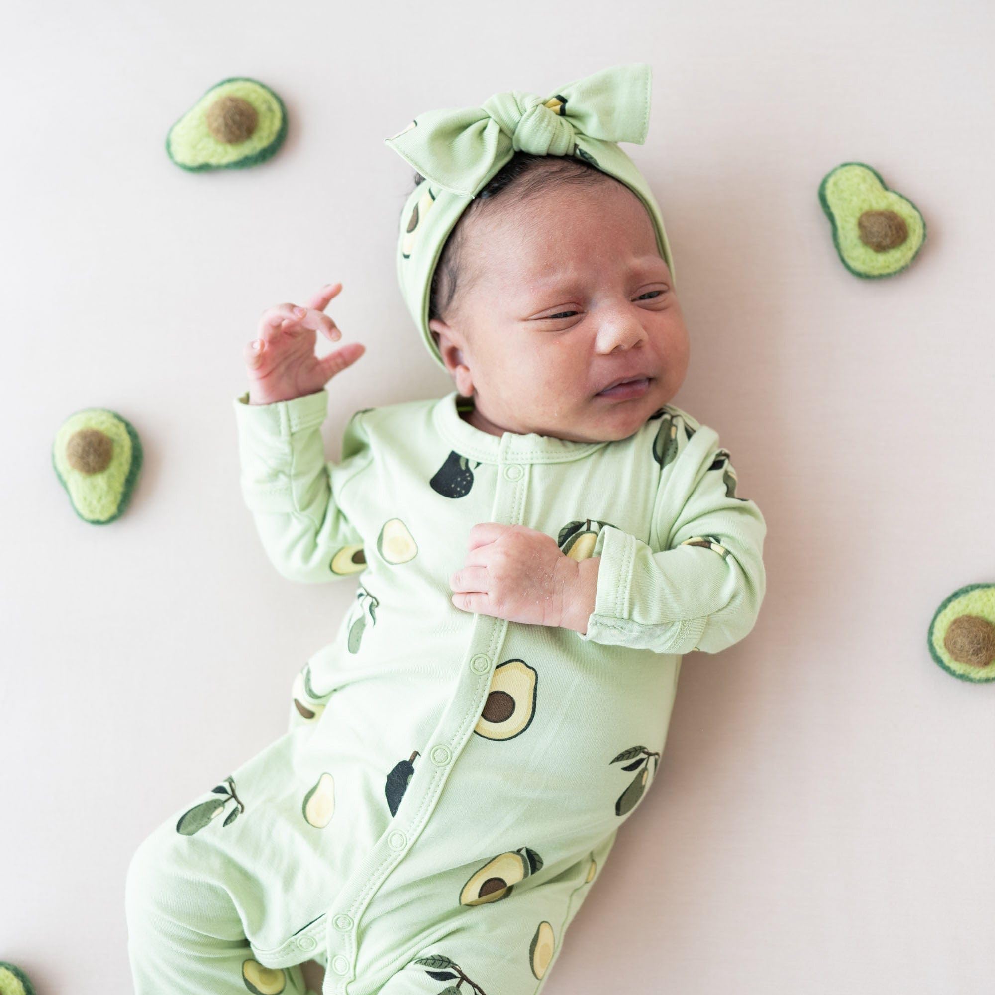 KYTE BABY bamboo bow avocado on baby illustrates soft comfort during wear.