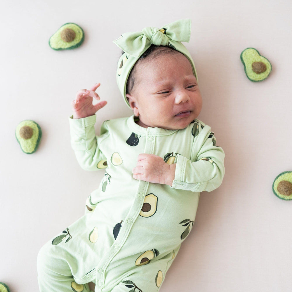 KYTE BABY bamboo bow avocado on baby illustrates soft comfort during wear.