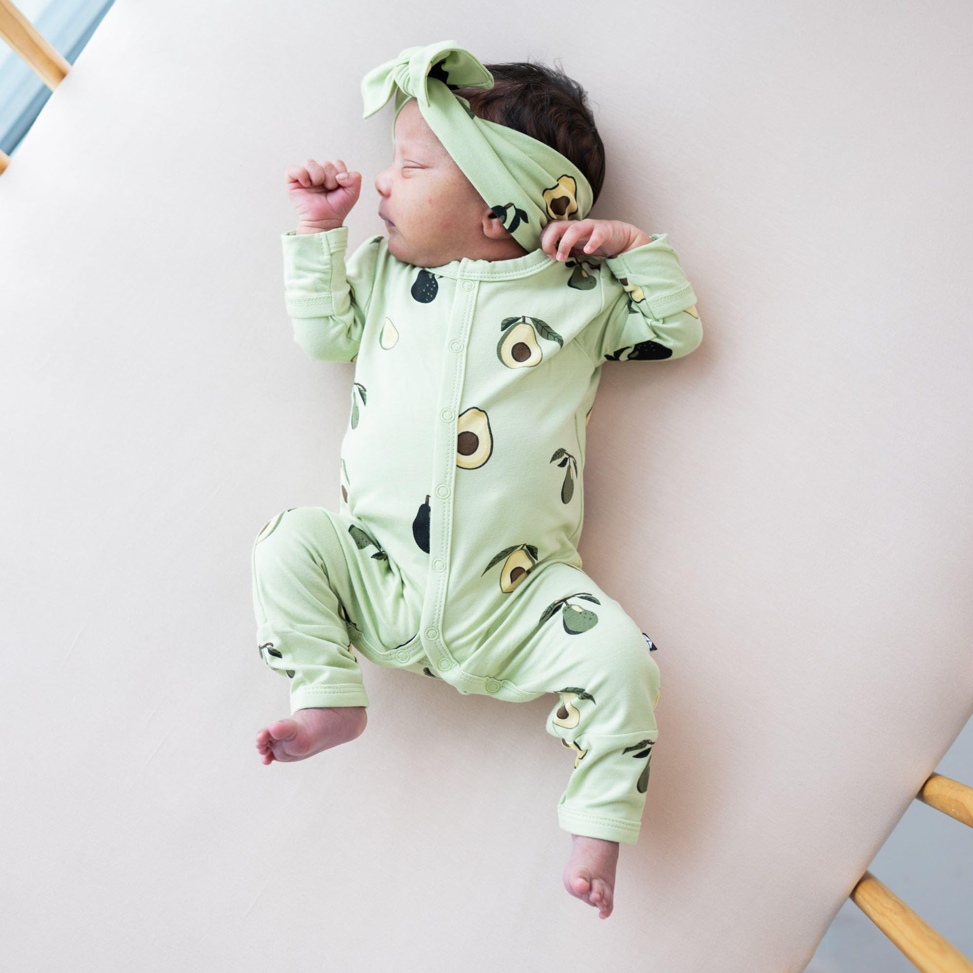 KYTE BABY bamboo bow avocado side view demonstrates secure, adjustable sizing.