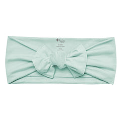 KYTE BABY bamboo bow sage back view highlights adjustable stretch for secure, gentle fit.