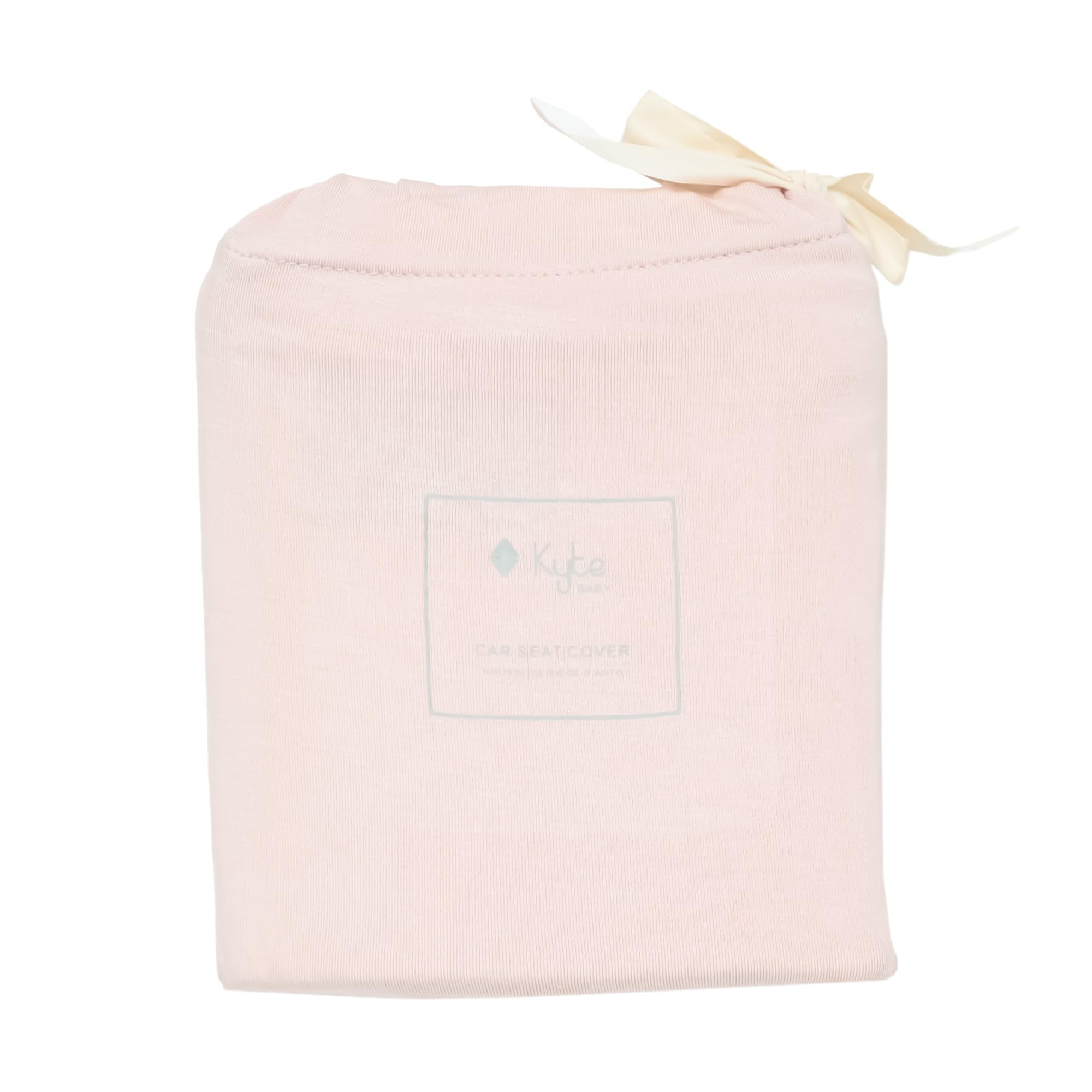 KYTE BABY car seat cover in blush folded closeup highlights lightweight fabric ideal for on-the-go moms.
