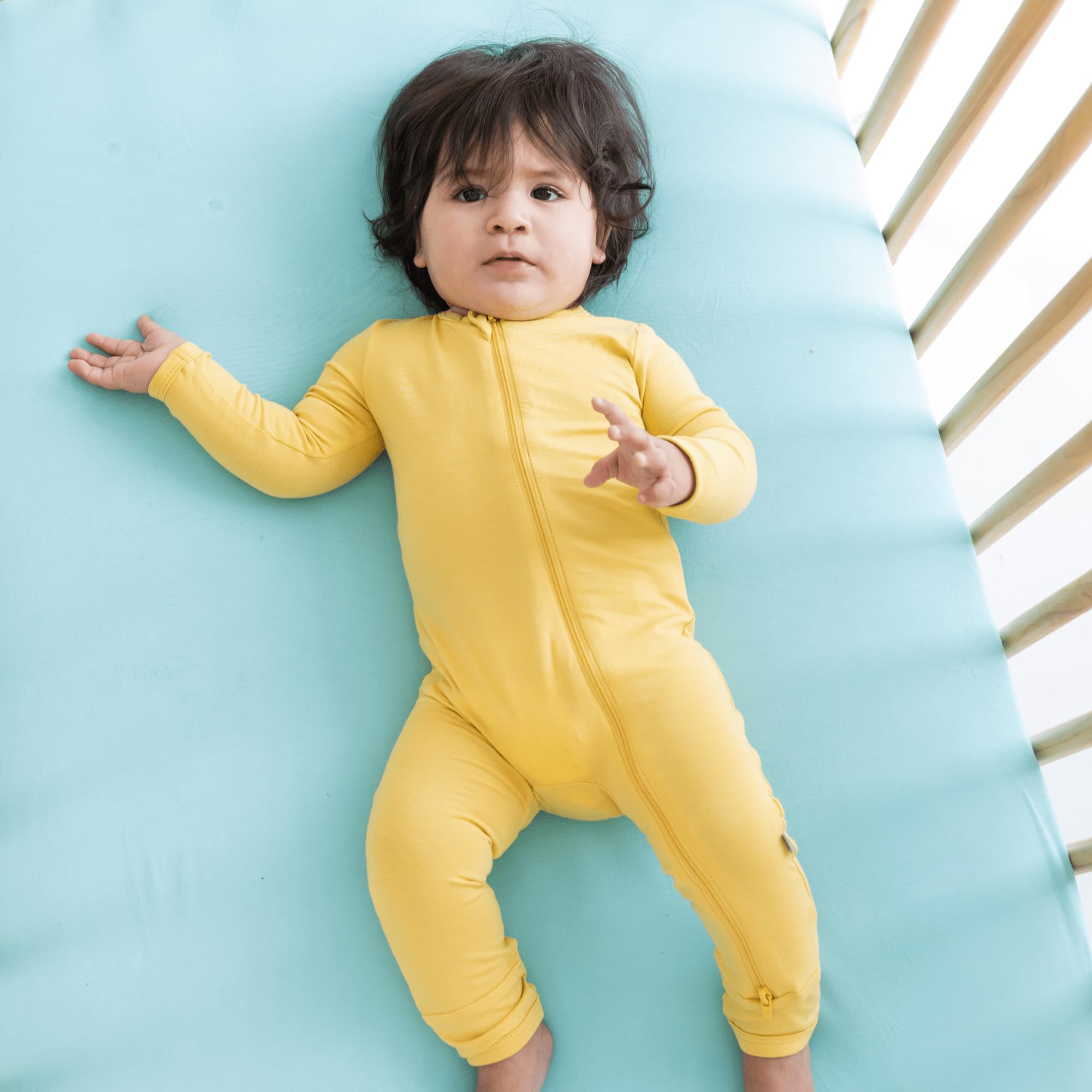 Kyte Baby crib sheet folded highlights smooth finish and silky texture