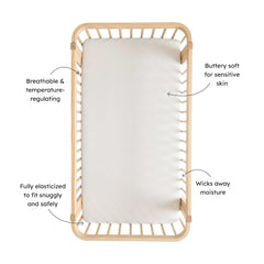 Kyte Baby crib sheet Rust Rainbow on Midnight on crib mattress demonstrates a snug, secure fit.