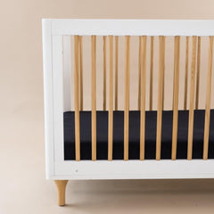 Kyte Baby midnight-snug-fit illustrates a secure 28x52 inch standard crib sheet.