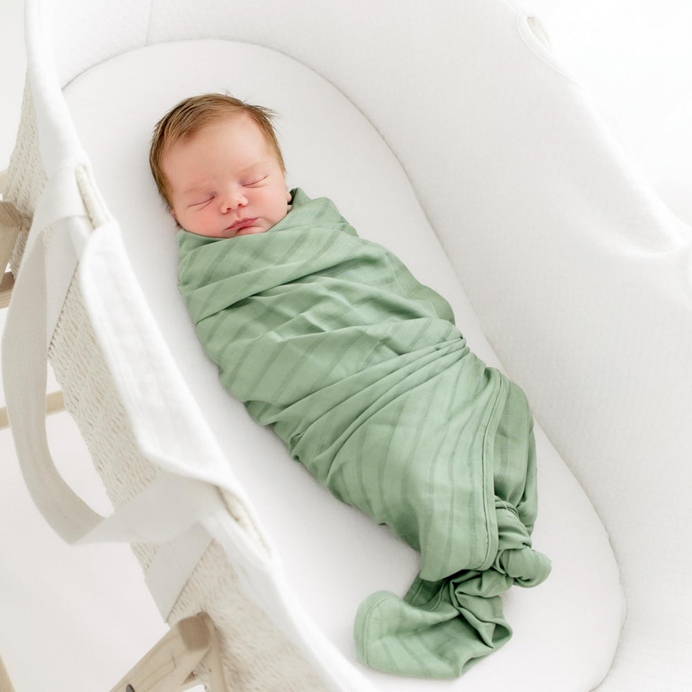 KYTE BABY rayon muslin swaddle with woven stripe detail for versatile use