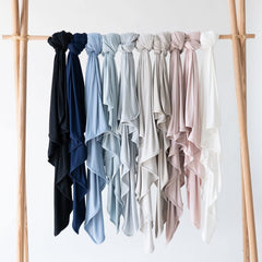 KYTE BABY slate swaddling blanket folded showcases versatile use for on-the-go sleep.