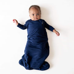 KYTE BABY navy sleep bag worn as wearable blanket for cozy nights.